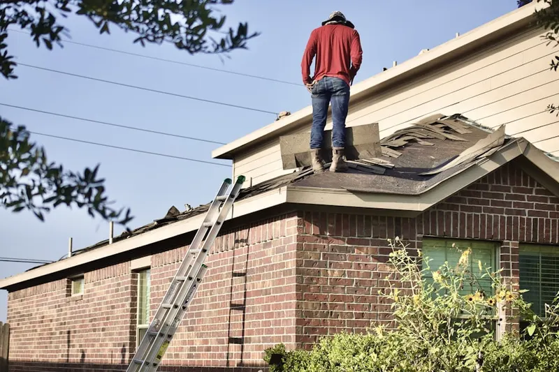 Professional roofer working on a residential roof in Dominion Hills